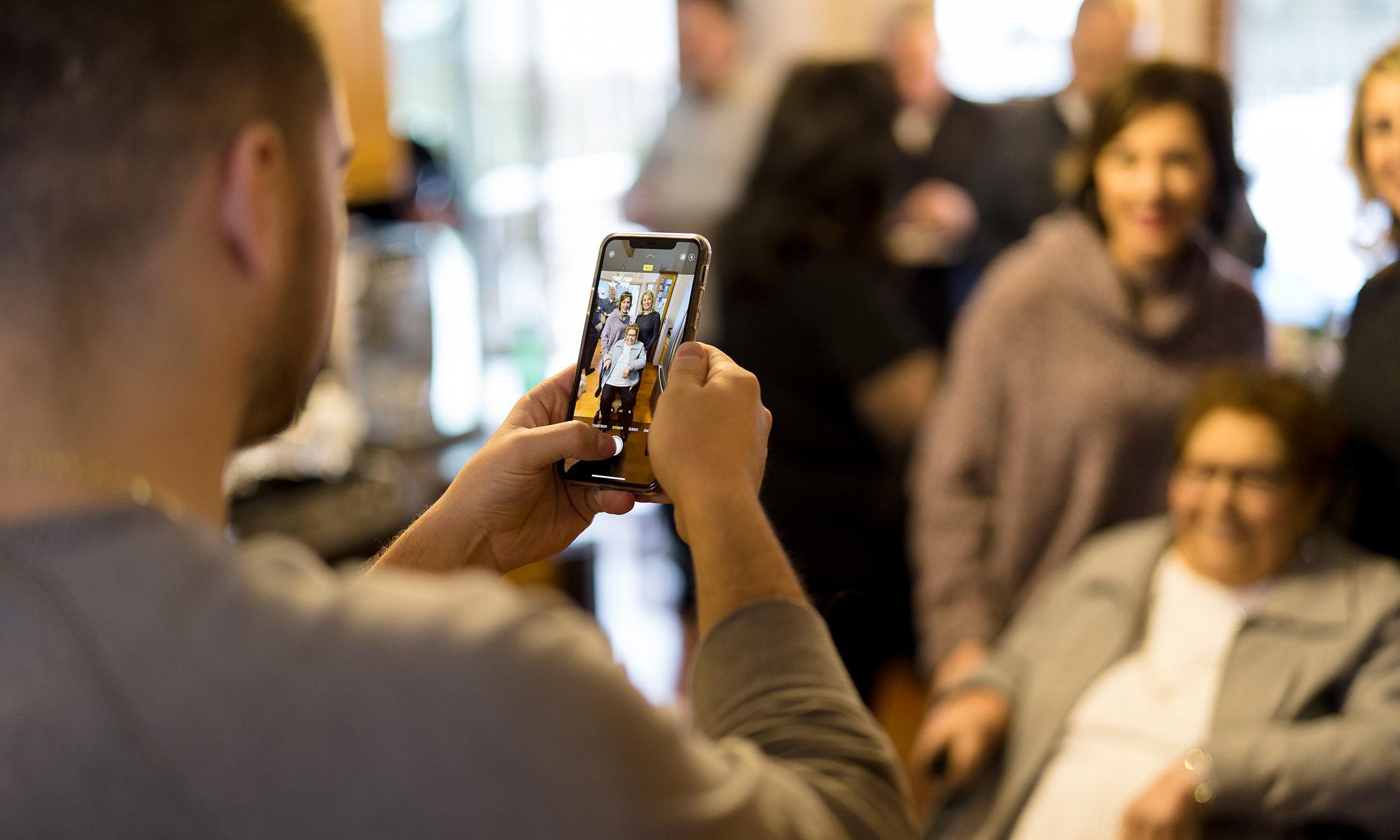 A man taking a photo of people.